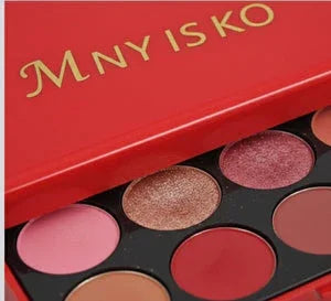 Red eyeshadow palette with assorted pink, brown, and shimmer makeup shades