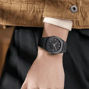 Black minimalist wristwatch on person’s wrist, modern casual fashion accessory